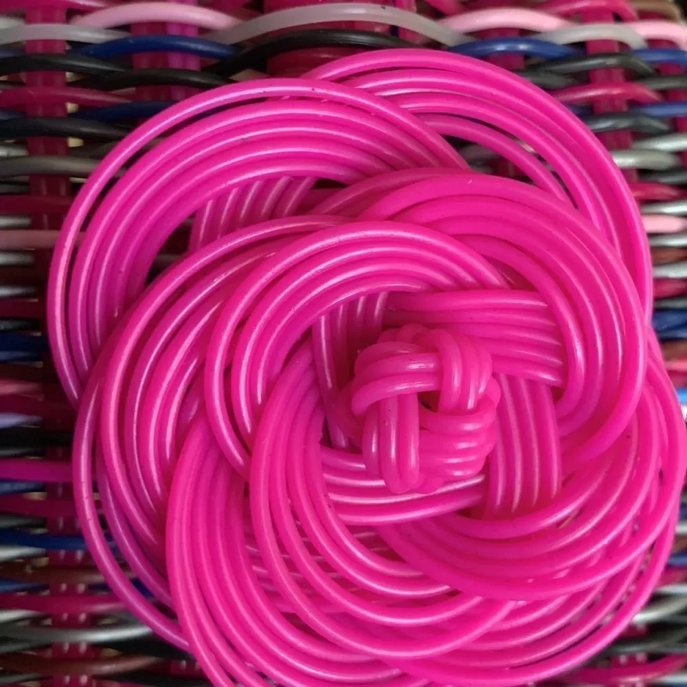 Handwoven plastic bag in multicolor with pink bottom and pink handles
